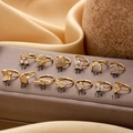 Detailed macro set of thirteen golden nose rings featuring butterfly and heart shapes - Four-leaf Clover Shape (1#) / Gold