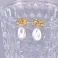 Elegant 18K gold-plated bow pearl earrings with cubic zirconia on a glass rim - 18K Gold
