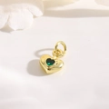 Detailed macro of 18k gold plated heart pendant with green zircon for jewelry DIY - Gold Heart / Green Zirconia