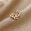Elegant gold heart brooch with baguette and round cut zircons on champagne silk fabric - Gold