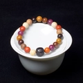 Macro detail of multicolored wooden beads bracelet resting on a white ceramic tea bowl - Multicolor (8mm*22 Beads Old Shape Style)