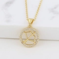 Macro shot of gold Sagittarius pendant featuring archer motif and sparkling crystals - Sagittarius