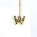 Close-up of golden bubble letter W pendant necklace with sparkling cubic zirconia stones - Letter W