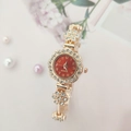 Detail of flower-shaped golden quartz watch with red dial and sparkling rhinestones - Rose Gold Case Red Dial