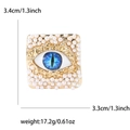 Detail der quadratischen Gold-Brosche mit blauem Auge, Perlen und Maßangaben - Dunkelblaues Auge / Dunkelblau