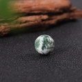 16mm white natural stone bead with green moss agate patterns on dark surface - Tree Agate