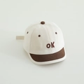 Close-up of baby baseball cap with embroidered OK lettering and short brim - Beige
