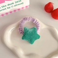 Plush purple scrunchie with green star charm on white cloud tray for cute hairstyles - Green Star