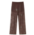 Detailed close-up of brown sheer mesh trousers with glittering sequin star embroidery - XS / Pants / Dark Brown