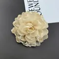 Detail of multi-layered cream chiffon chrysanthemum fabric flower for dresses - Beige