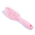 Detailed view of pink vented hairbrush with spiral hollow design and flexible ball-tip bristles - Pink