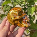Macro view of 7cm aura crystal skull with orange tones and iridescent rainbow finish - 7cm / Electroplated Yellow