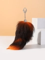 Macro shot of fluffy orange and brown faux fox tail keychain with silver metal clip - Black Orange