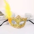 Macro view of carnival lace mask featuring golden feathers and silver sequin details - Yellow