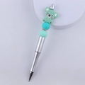 Close-up of DIY beaded pen featuring a green koala silicone charm and mint green beads - Green Koala