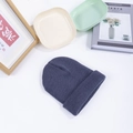 Dark gray knitted beanie hat for men and women shown in a cozy lifestyle setting - M (56-58cm) / Gray