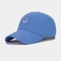 Close-up of bright blue cotton baseball cap with white smiley face embroidery detail - Adjustable / Sky Blue