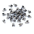Macro shot of gun-black metal ribbon crimp ends for jewelry making on white background - Gunmetal
