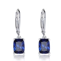 Detail of silver leverback earrings with rectangular blue topaz gemstones and zircon accents - Blue