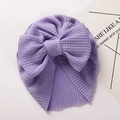 Detail of lavender baby turban featuring waffle texture and a large soft bow decoration - Purple