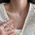 Minimalist S925 sterling silver water drop necklace and ring set worn by a model - Interlocking Rings Style
