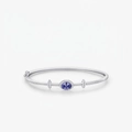 Elegant s925 silver bangle with oval blue sapphire and pavé diamonds on a grey background - 925 Silver / S925 Sterling Silver (Blue Gemstone)