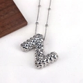 Detailed macro view of silver necklace with letter Z pendant and stud texture - Letter Z