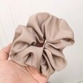 French style large champagne satin scrunchie with silky texture held in hand - Khaki
