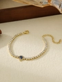 Detail of gold tennis bracelet featuring white zircons and blue teardrop stone - Blue Waterdrop Style (ZHB696)