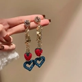 Dettaglio degli orecchini a nappa con stelle, fragola rossa e ciondolo a cuore blu - Perno in Argento Fragola Nappa
