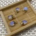 Five pieces of purple opal faceted oval pendants with golden metal caps and hanging loops - Opal