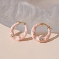 Detailed close-up of pink marbled C-shape earrings with gold plating and rhinestones - Pink Hoop