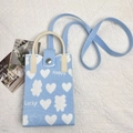 Detail of light blue knitted phone bag with white bear heart patterns and leather handle - Blue Heart-Happy