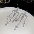 Elegant silver cross tassel earrings with sparkling crystals on white ceramic plate - Silver (Silver Pin)