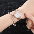 Detail of rose gold quartz watch with shell dial and matching star pendant bracelet - Black And Bracelet