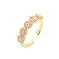 Macro shot of gold-plated evil eye flower ring with pink enamel and cubic zirconia stones - Adjustable Open / Pink