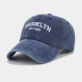 Detailed embroidery of white BROOKLYN EST 1631 text on washed navy blue baseball cap - Adjustable / Navy Blue