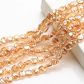 Detailed view of faceted amber glass beads strands hanging on white geometric prop - Amber Gold