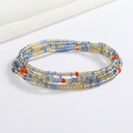 Detail of bohemian waist chain with colorful glass seed beads in blue and gold tones - Blue Gold Red