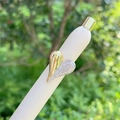 Close-up of heart ring with 18K gold plating and pavé rhinestones on white stand - Two-tone Heart Style