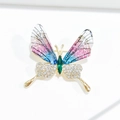Macro detail of butterfly brooch with colorful enamel wings and green gemstone body - Gradient Purple Butterfly