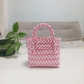 Close-up of pink and white woven tote bag texture with durable plastic handle - Mini Pink Contrast