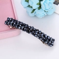 Close-up of luxury hair clip with navy blue crystals on pink velvet jewelry box display - Navy Blue