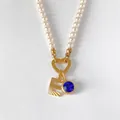 Elegant pearl necklace featuring a 14K gold plated letter E and blue crystal charm - Letter E