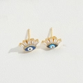 Détail de boucles d'oreilles œil maléfique dorées avec émail bleu et zircons clairs - Style Cils / Cils Bleu Roi