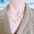 Elegant gold butterfly necklace with rectangular zircon crystals worn on a beige blazer - White Rhinestone Butterfly