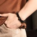 Men's obsidian bead bracelet set with woven cord and crown charm on male wrist - Braided Square