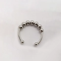 Detailed macro view of seven rotatable metal beads on an open anxiety ring band - Adjustable Open / Silver