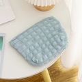 Light blue bubble puff texture quilted makeup bag for travel with metal zipper on table - Blue