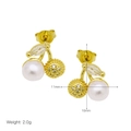 Detail view of gold cherry earrings with white pearls and sparkling cubic zirconia - Pave Zirconia Pearl Cherry Studs / 11mm x 10mm